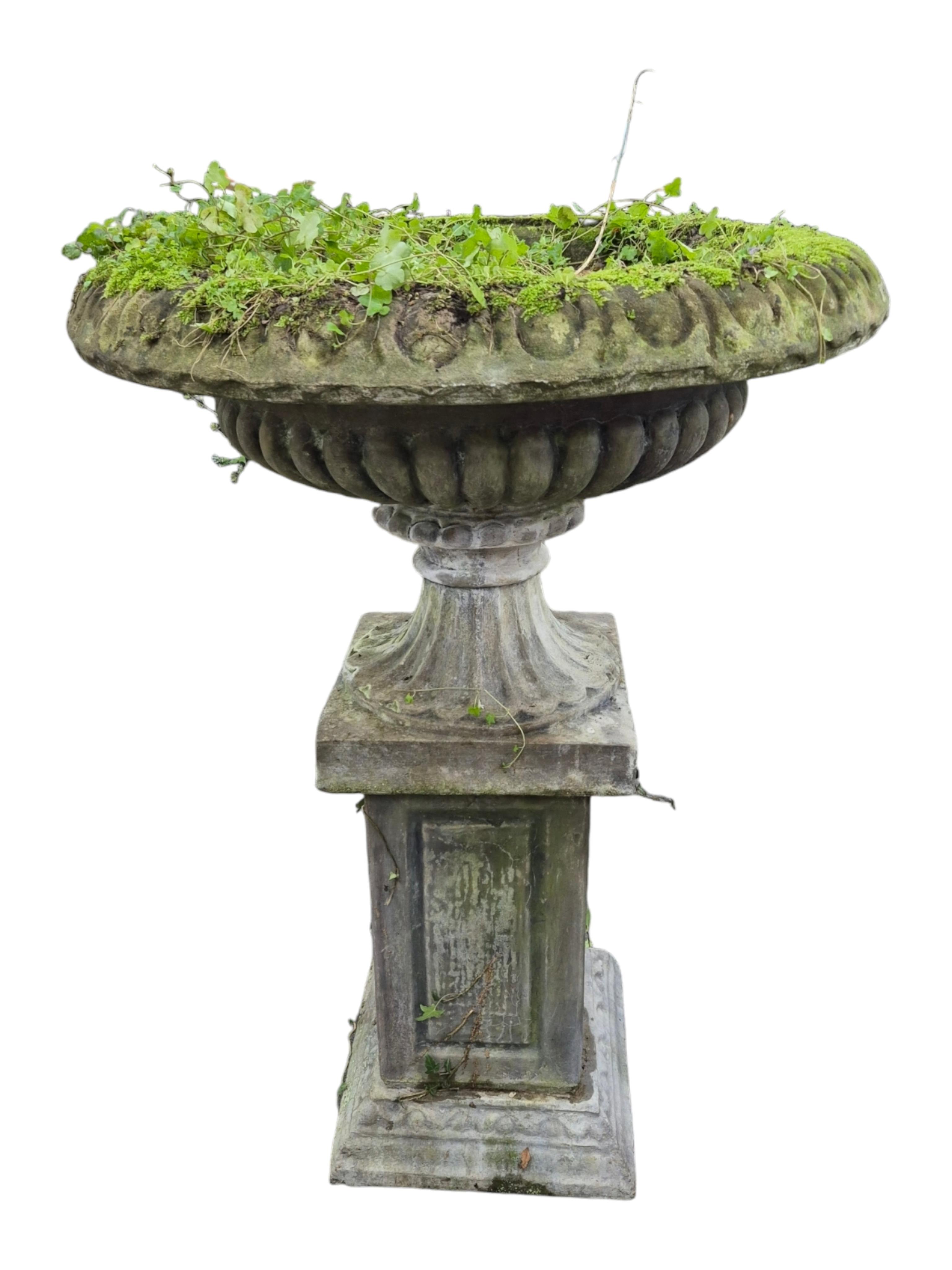 A large reconstituted stone garden vase